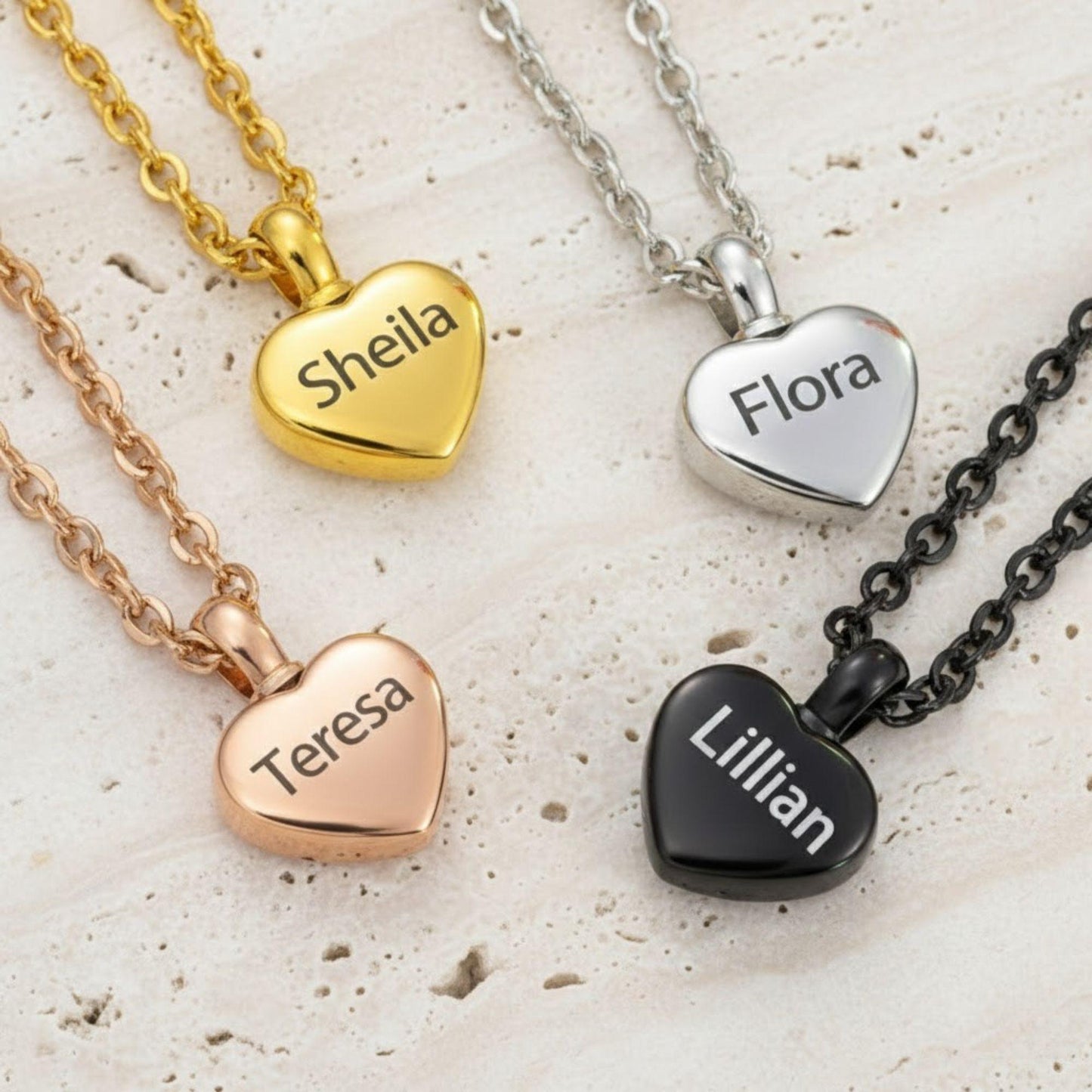 Heart-shaped name pendants on various colored chains on a textured surface